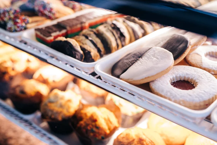 Cookies, rainbow cookies, and muffins in the bakery case