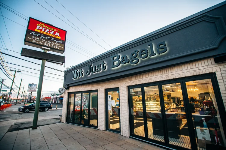 Not Just Bagels storefront on Hylan Boulevard at dusk
